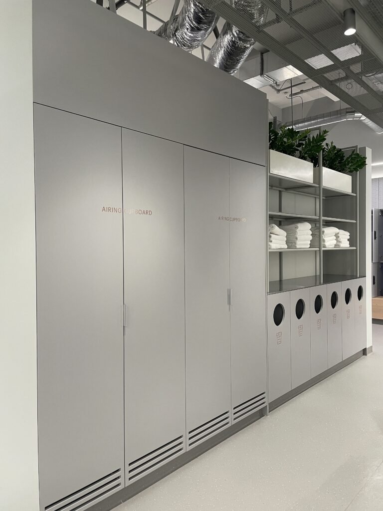 Hotel storage area featuring lockers made of high pressure laminate panels and stainless steel.
