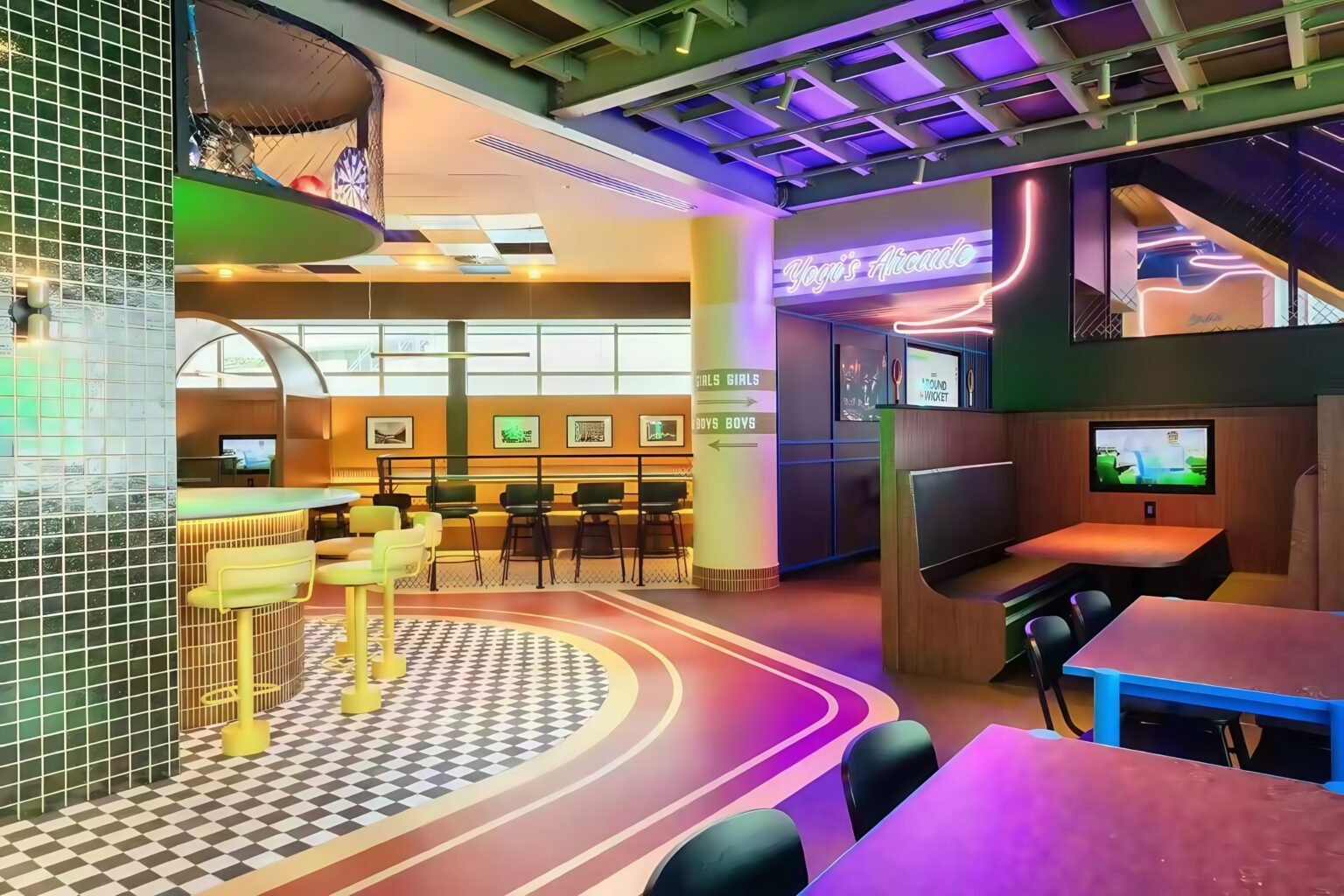Vibrant modern sports bar interior with illuminated cocktail counter, neon signage, checkered flooring, and colorful ambient lighting design
